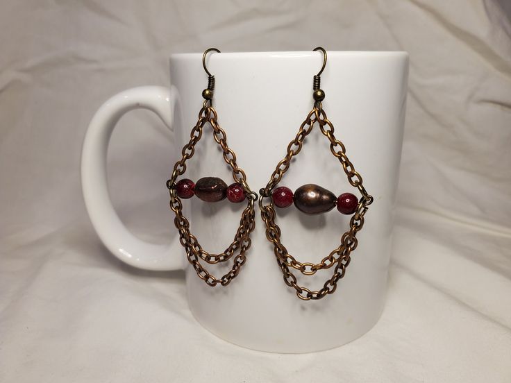 Bronze colored chain with brown colored bead Metal Beaded Chain Dangle Earrings, Metal Drop Earrings With Beaded Chain, Brown Beaded Chain Jewelry For Parties, Brown Metal Chain Jewelry, Brown Wire Wrapped Dangle Earrings, Brown Dangling Beads Jewelry For Party, Brown Metal Dangle Earrings, Brown Dangle Metal Earrings, Brown Chain Jewelry As A Gift