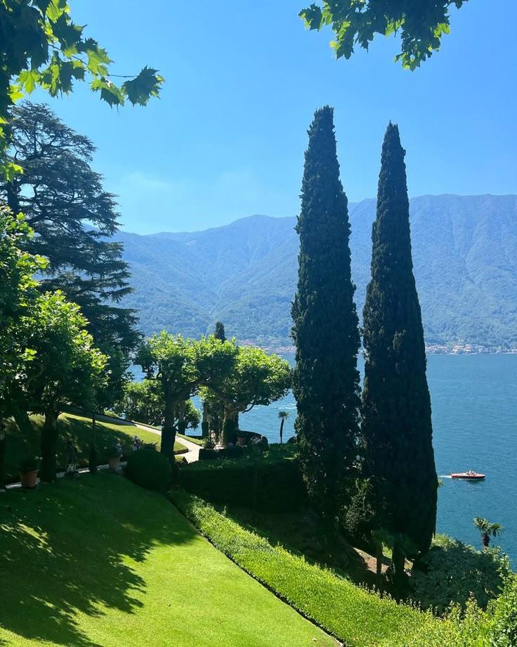 an image of a beautiful view of the water and trees in the foreground with mountains in the background