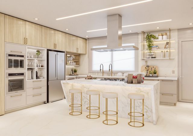 a large kitchen with marble counter tops and gold stools in front of the island