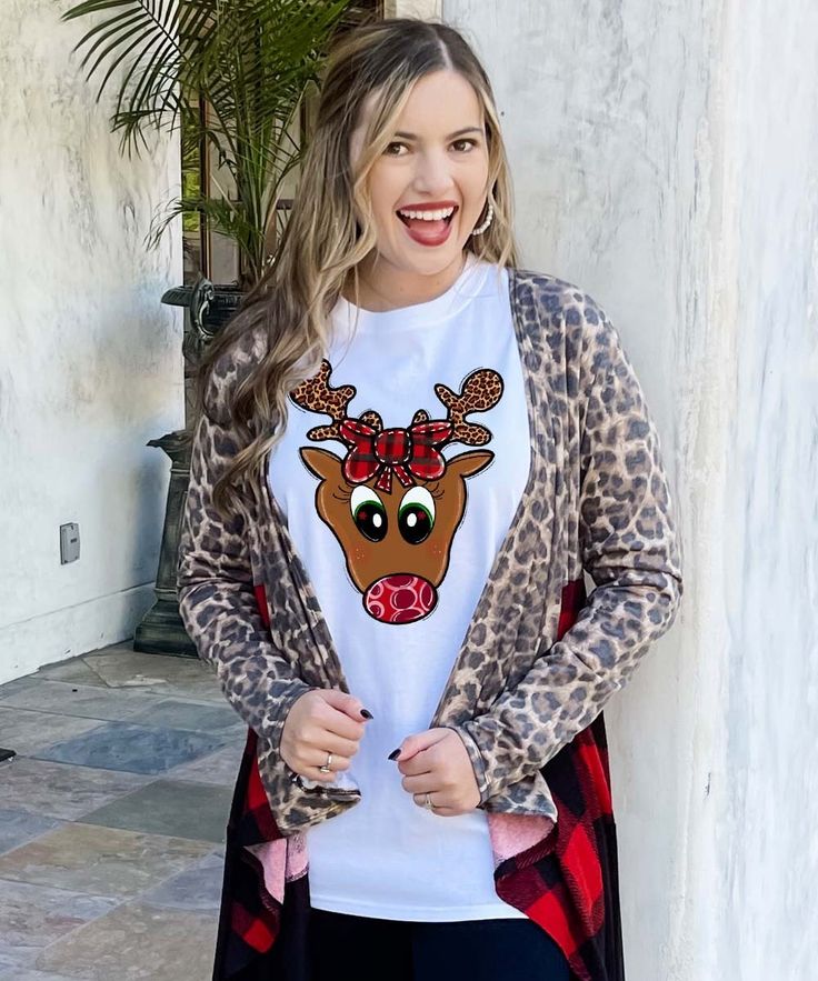 Get in the holiday spirit with this Reindeer Face Graphic Shirt. This festive design pairs perfectly with leggings, a vest, and booties! Show your Christmas spirit in a big way this year. Available in youth to adult.

*6.0 oz., pre-shrunk 100% cotton *Double-needle stitched neckline and sleeves*Quarter-turned*Seamless seven-eighths inch collar*Taped neck and shoulders*Satin label*Rib cuffs Reindeer Face, Black Friday Christmas, Beach Birthday, Graphic Tee Shirts, Girly Girl, Christmas Spirit, Graphic Shirts, Reindeer, Christmas Sweaters