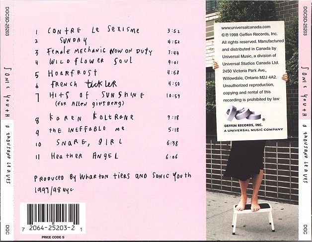 the back side of a pink and black book with an image of a woman holding a sign