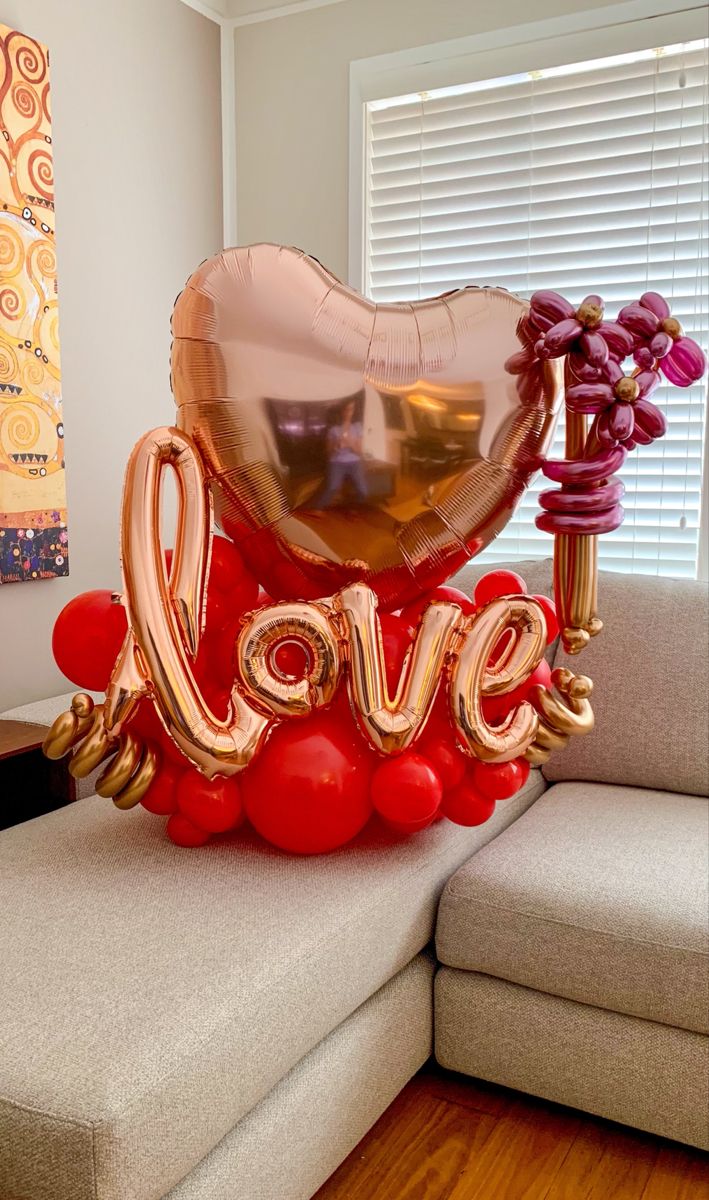 a love balloon sitting on top of a couch