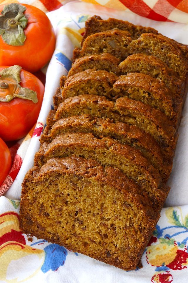 sliced loaf of bread sitting on top of a table next to tomatoes