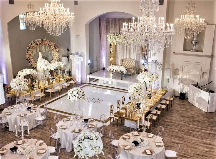 an elegant ballroom with chandeliers and tables set up for a formal dinner or reception