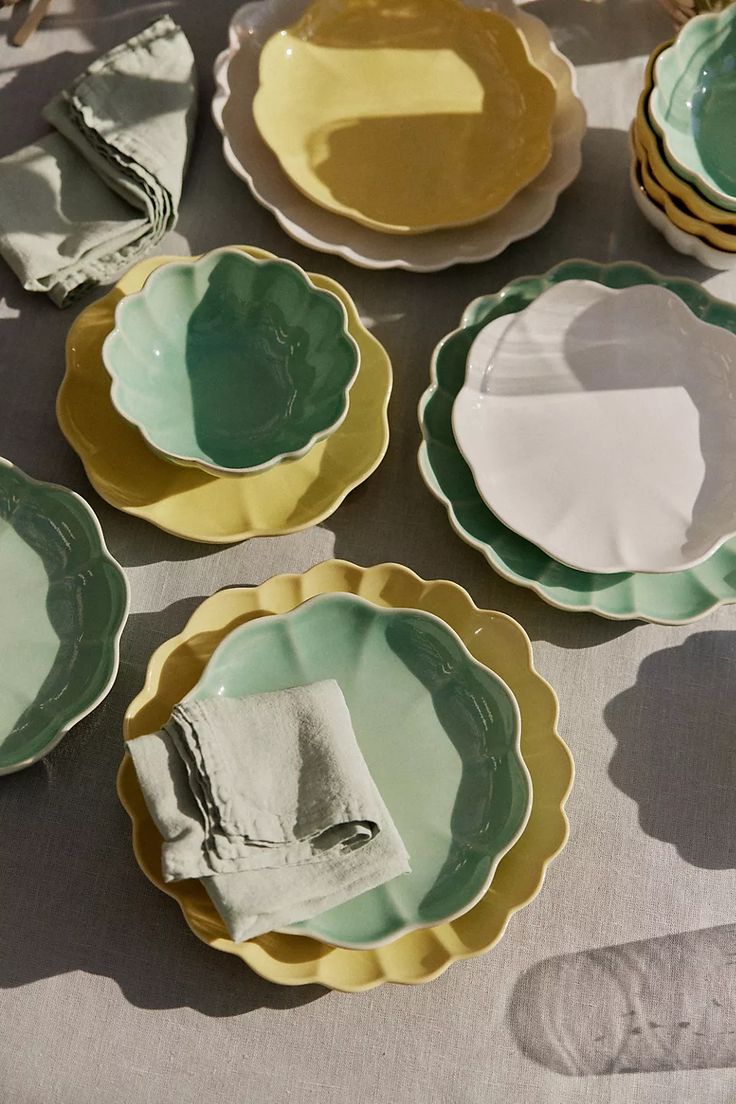 several plates are arranged on a table cloth