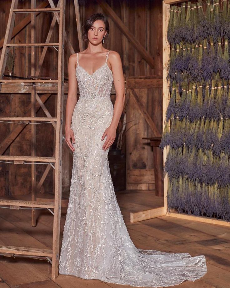 a woman in a wedding dress standing next to a ladder