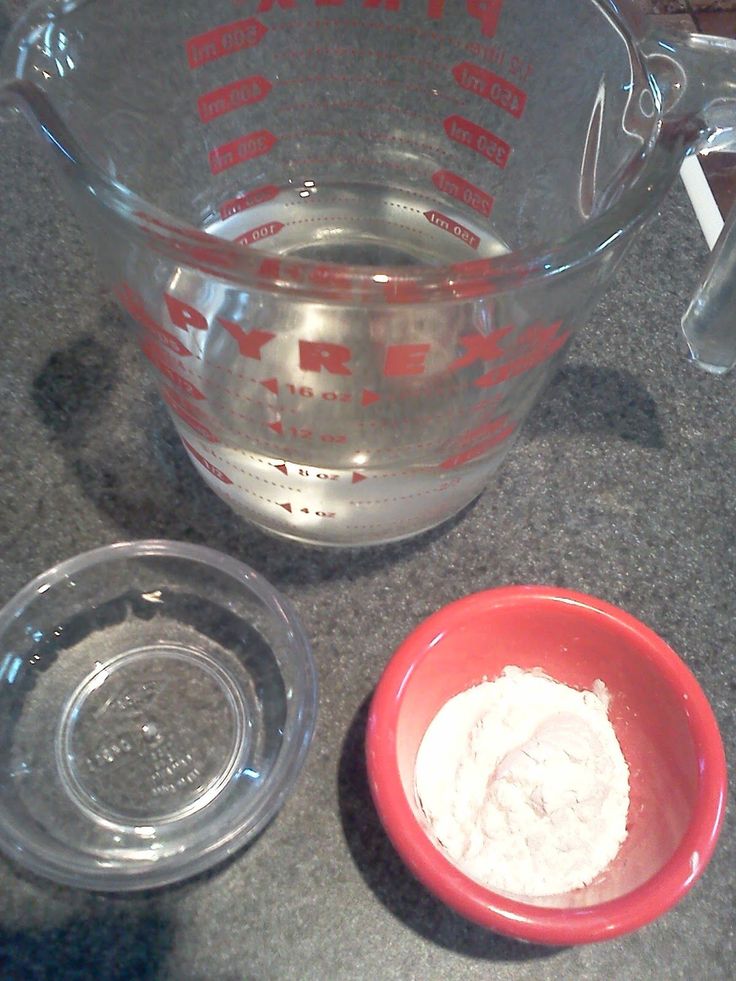 a blender with some ingredients in it on a counter top next to a red bowl