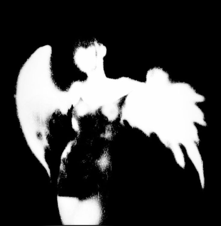 an angel is standing in the dark with its wings spread out and it appears to be white