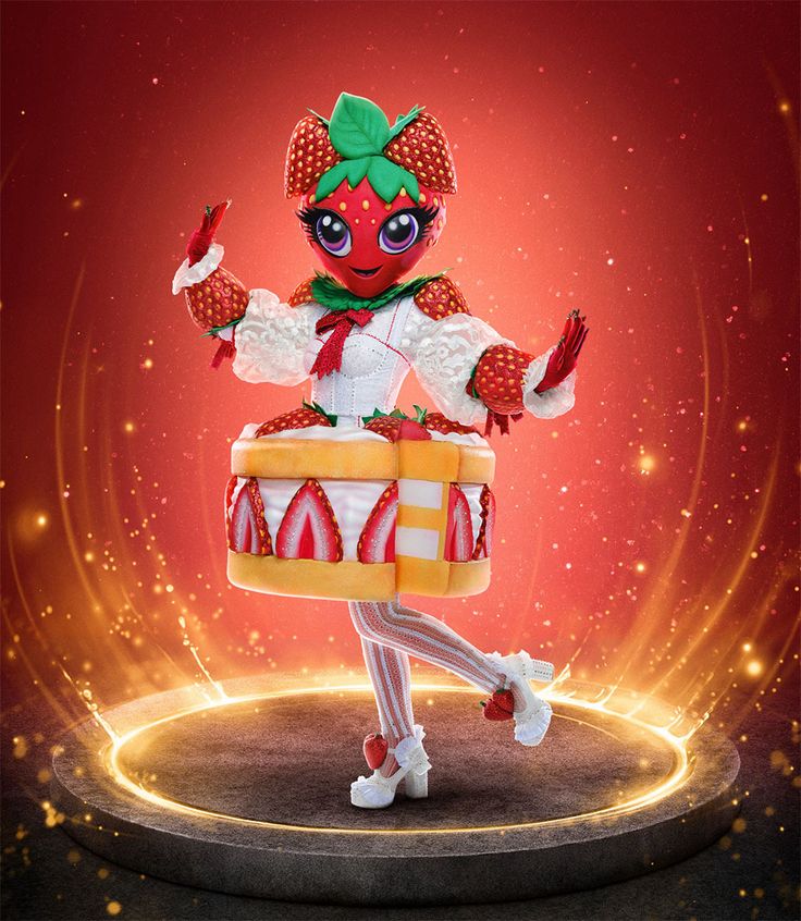 a doll dressed as a clown holding a box with candy on it's legs