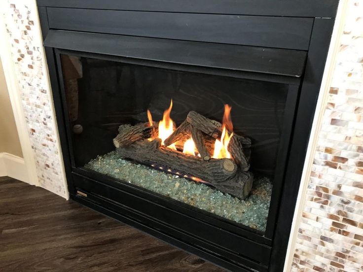 a fire is burning in a fireplace with logs