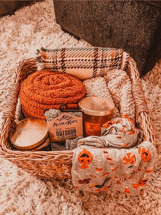 a wicker basket filled with lots of items on top of a white carpeted floor