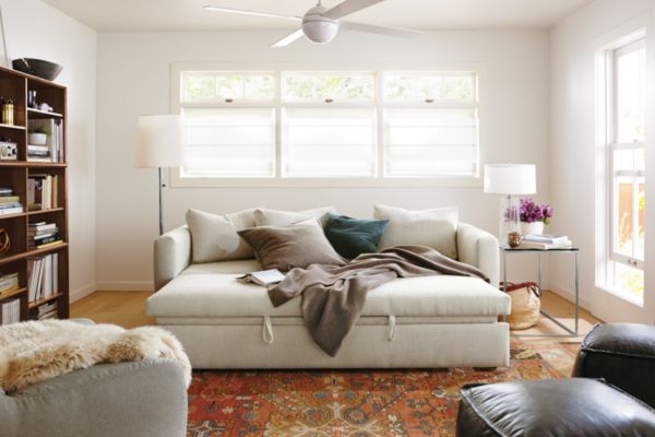 a living room filled with furniture and a large window