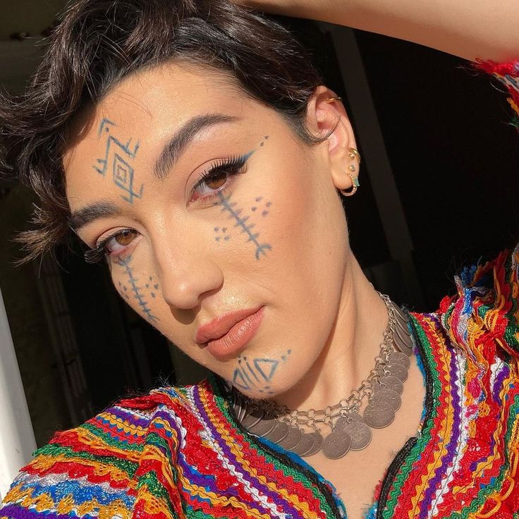 a woman with tattoos on her face and neck