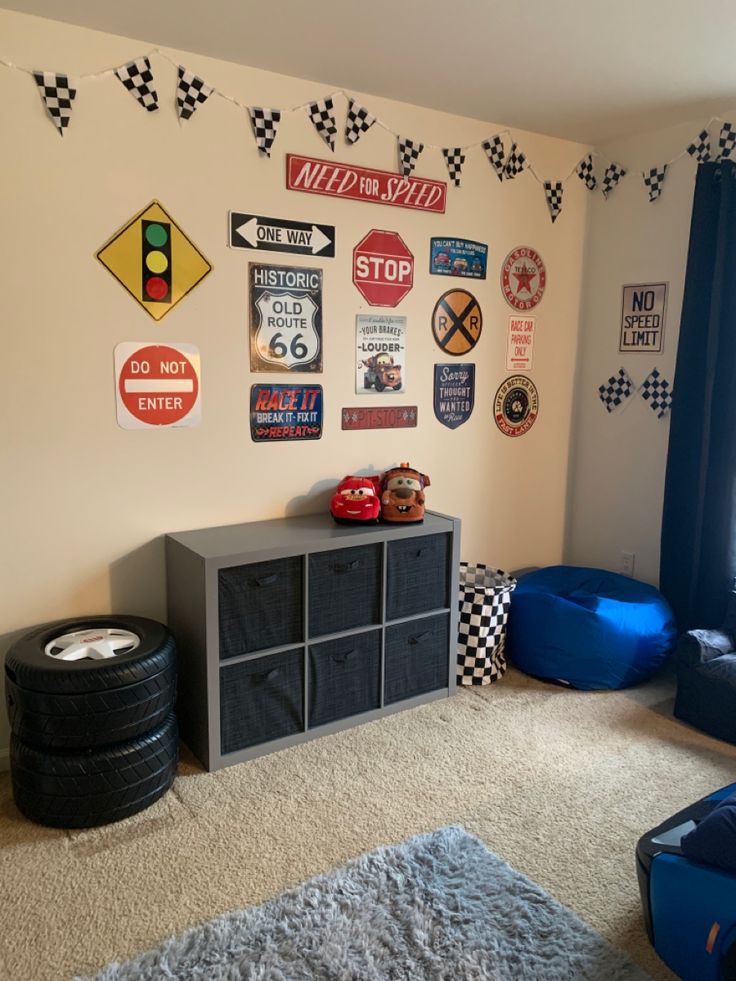 a room with lots of signs on the wall and furniture in it, including a toy car