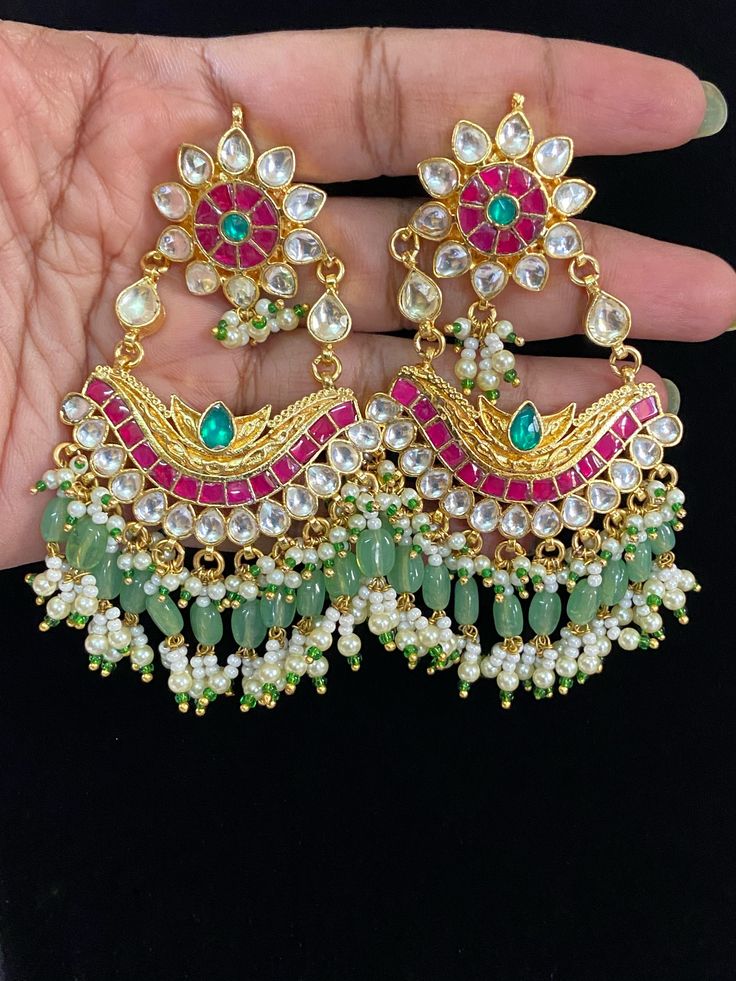 Elevate your style with these exquisite Jadau Kundan earrings. Handcrafted with precision, these earrings are perfect for parties and bridal wear. The intricate detailing and premium materials make these earrings a statement piece for any occasion. Elegant Bridal Chandbali Meenakari Earrings, Fusion Style Party Chandelier Earrings With Stone Work, Fusion Kundan Chandelier Earrings For Reception, Kundan Chandelier Earrings For Reception, Fusion Style Hand Set Chandelier Earrings For Party, Elegant Chandbali Bridal Earrings With Tilla, Festive Stone Work Chandelier Earrings For Reception, Intricate Design Drop Earrings For Reception, Fusion Style Bridal Earrings With Stone Work For Party