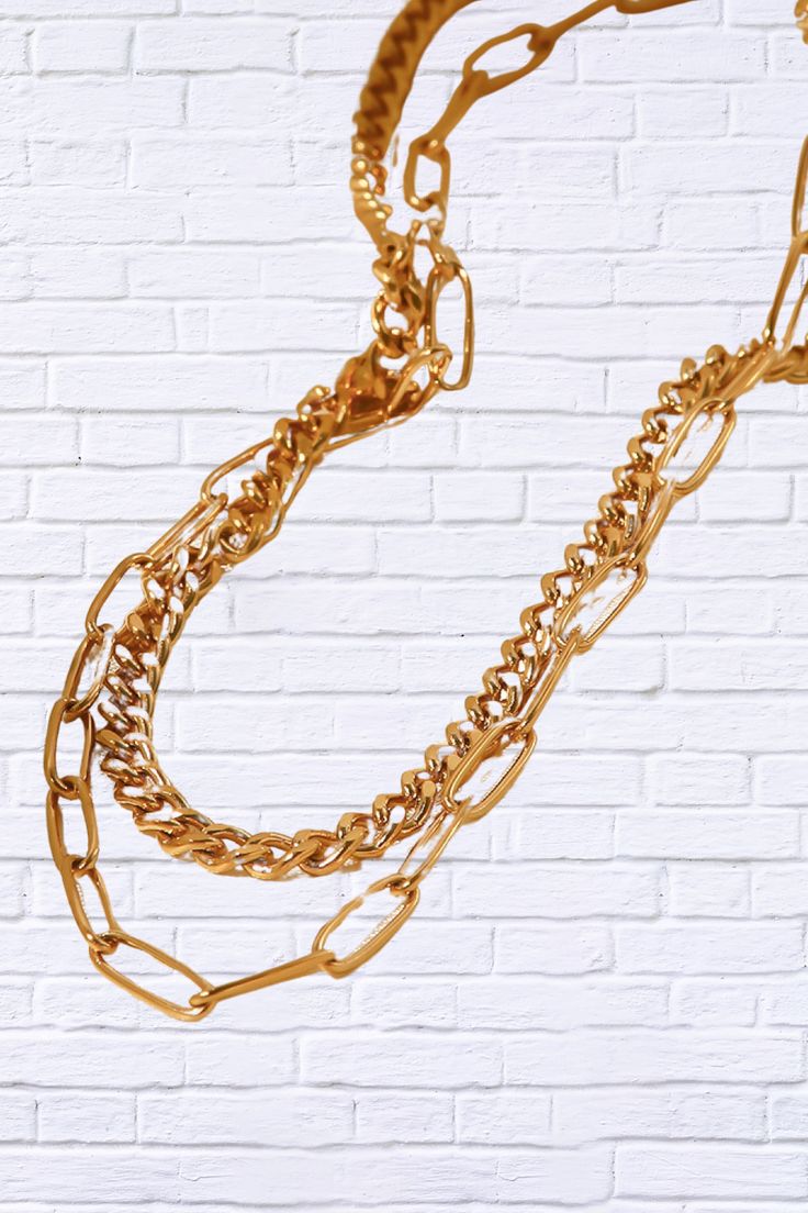 Step up your style game with our 18K Gold Plated Layered Chain Necklace, a statement piece that effortlessly combines elegance and trendiness. This layered necklace features multiple delicate chains, each plated in luxurious 18K gold, creating a stunning, layered look that adds depth and dimension to any outfit. Whether you’re dressing up for a night out or adding a touch of glam to your everyday attire, this versatile necklace is designed to make you shine. Key Features: 18K Gold Plating for a Layered Chain Necklace, Layered Chain, Versatile Jewelry, Layered Chains, Trendy Necklaces, Gold Necklace Layered, Elegant Necklaces, Layered Necklace, Unique Outfits