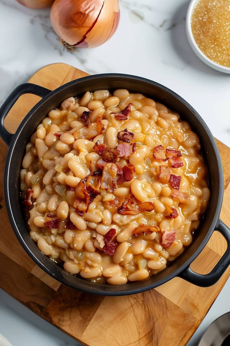 a pot filled with macaroni and cheese on top of a wooden cutting board