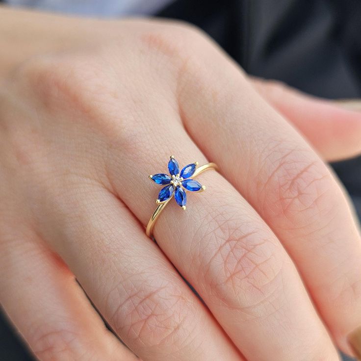 💎Add a touch of elegance to your jewelry collection with this stunning 14K Gold Sapphire Flower Ring. The intricate design features a dazzling Diamond Statement Ring centerpiece surrounded by beautiful Marquise Blue Gemstones. This Unique Ring for Women is the perfect September Birthstone accessory and makes a meaningful Birthday Gift that will be cherished for years to come. 💎We can make our product on the list in the colored stones you want. Feel free to send us a message so we can check. 💎 Elegant Blue Flower Ring As Gift, Blue Flower Rings For Formal Occasions, Blue Gemstone Flower Ring, Elegant Flower Ring With Birthstone For Anniversary, Elegant Diamond Flower Ring With Birthstone, Blue Flower Shaped Gemstone Ring, Elegant Blue Diamond Flower Ring, Blue Flower Gemstone Rings, Blue Flower-shaped Gemstone Ring