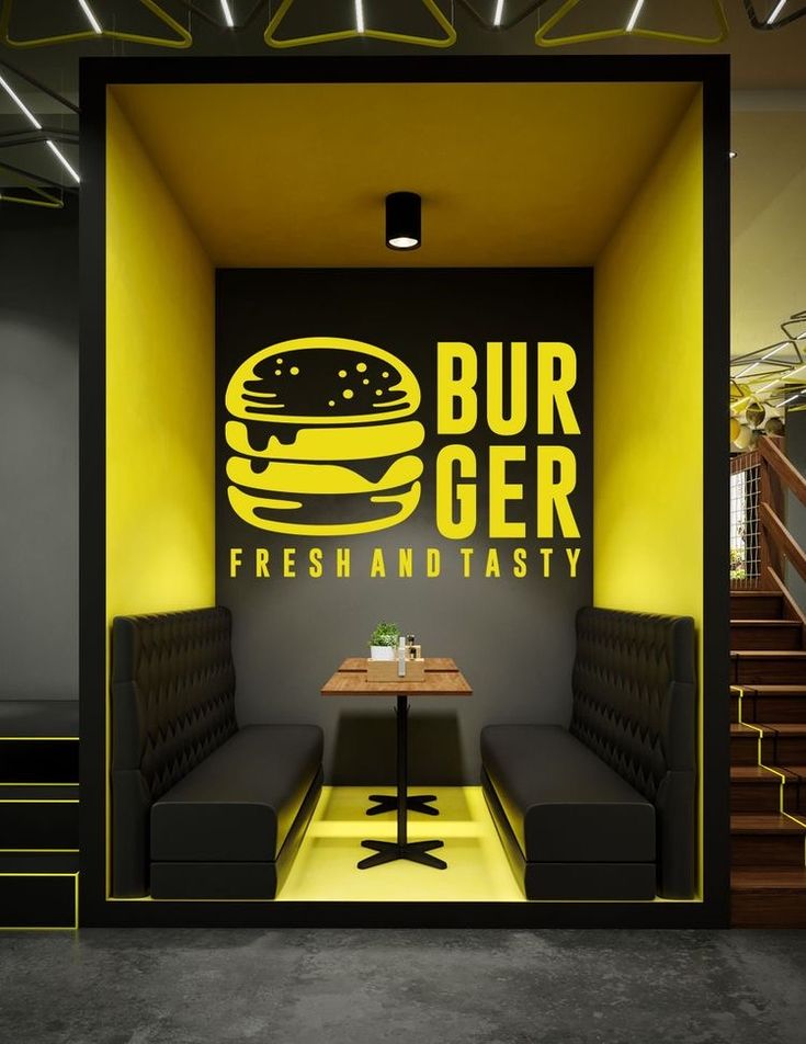 the interior of a fast food restaurant with neon lights and black walls, along with yellow accents