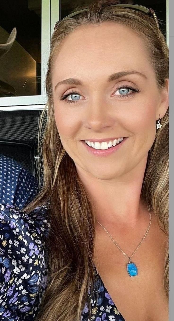 a woman with blue eyes smiling for the camera