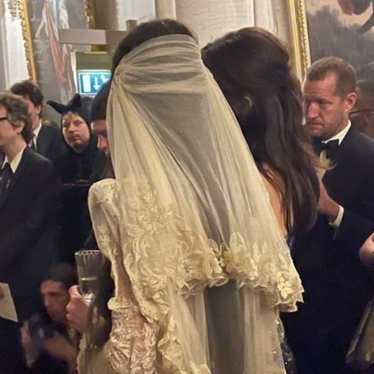 a woman in a wedding dress standing next to a man