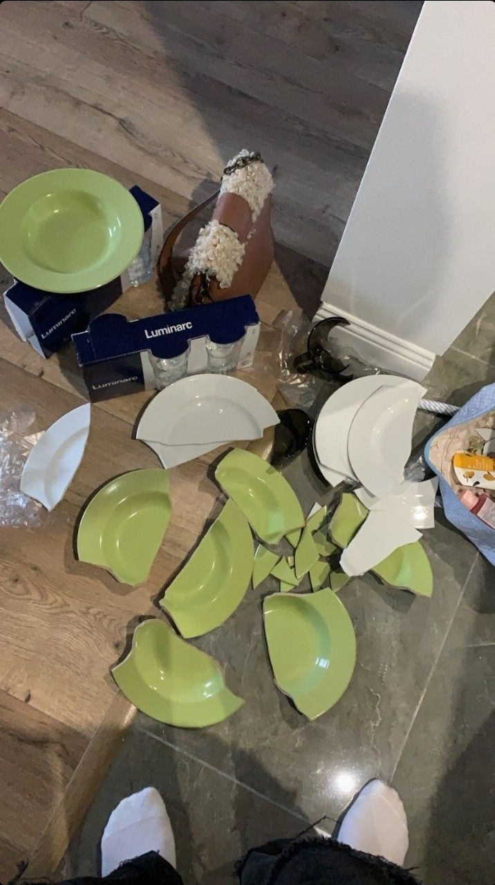 there are many plates and bowls on the floor