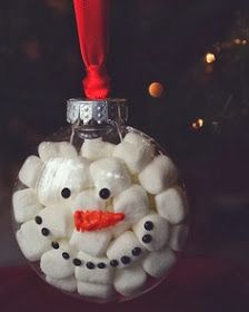 a glass ornament with marshmallows in the shape of a snowman