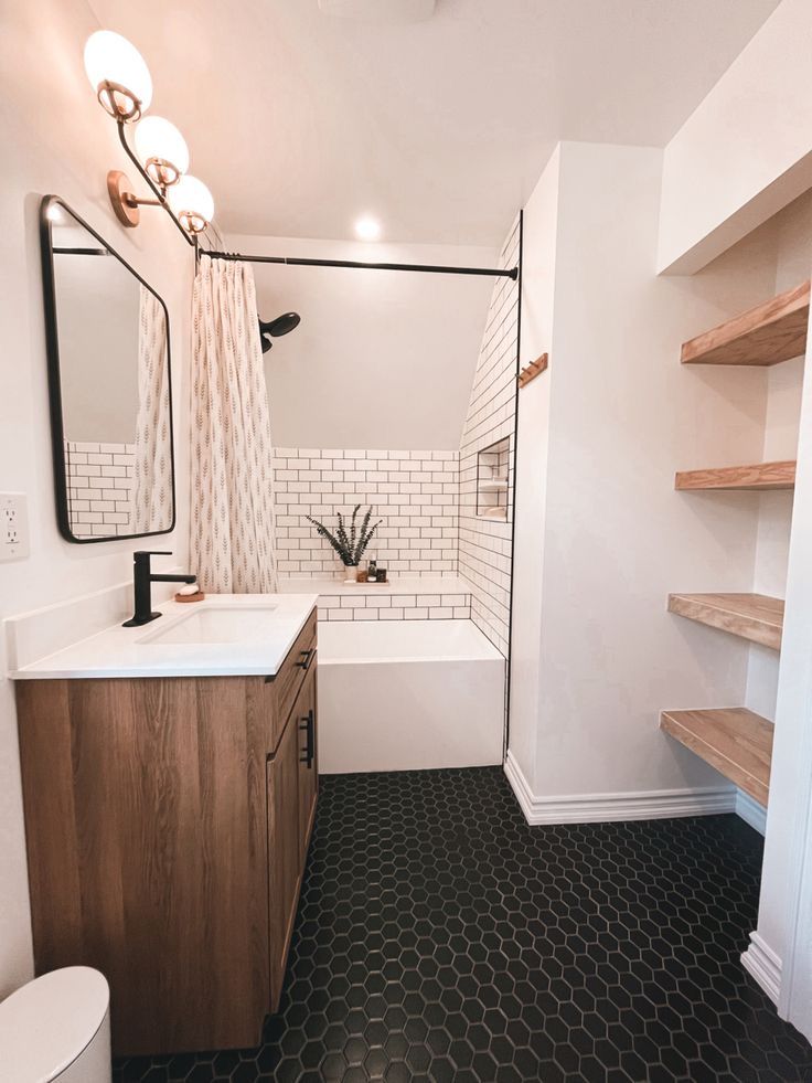 a bathroom with black and white tile flooring