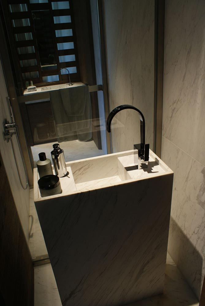 a bathroom sink sitting under a mirror next to a window