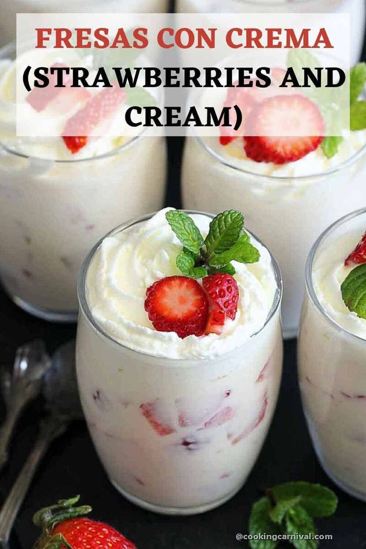 three glasses filled with strawberries and cream on top of a black table next to silverware