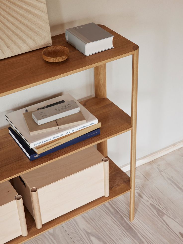 a wooden shelf with books and other items on it