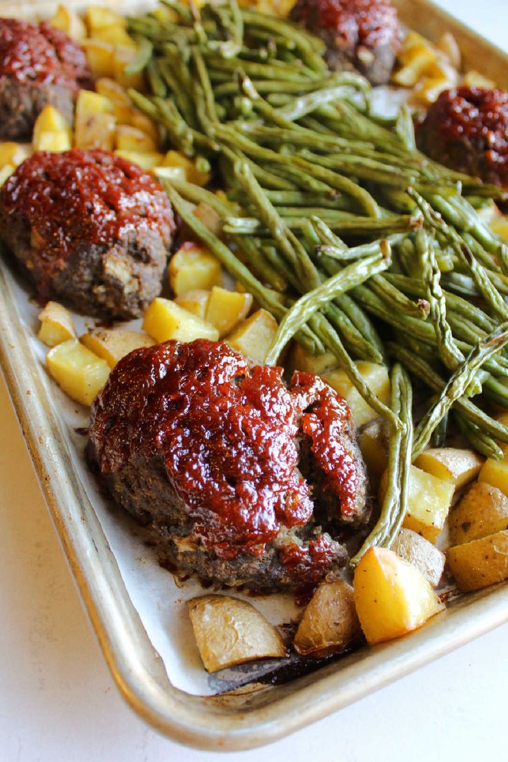 meatballs, potatoes and green beans on a tray