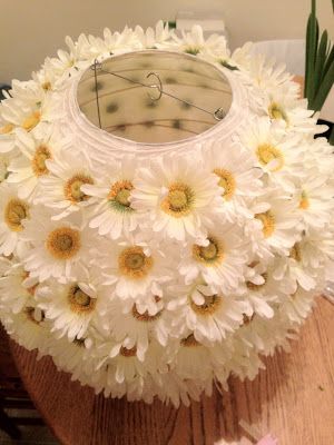 a clock made out of flowers sitting on top of a wooden table