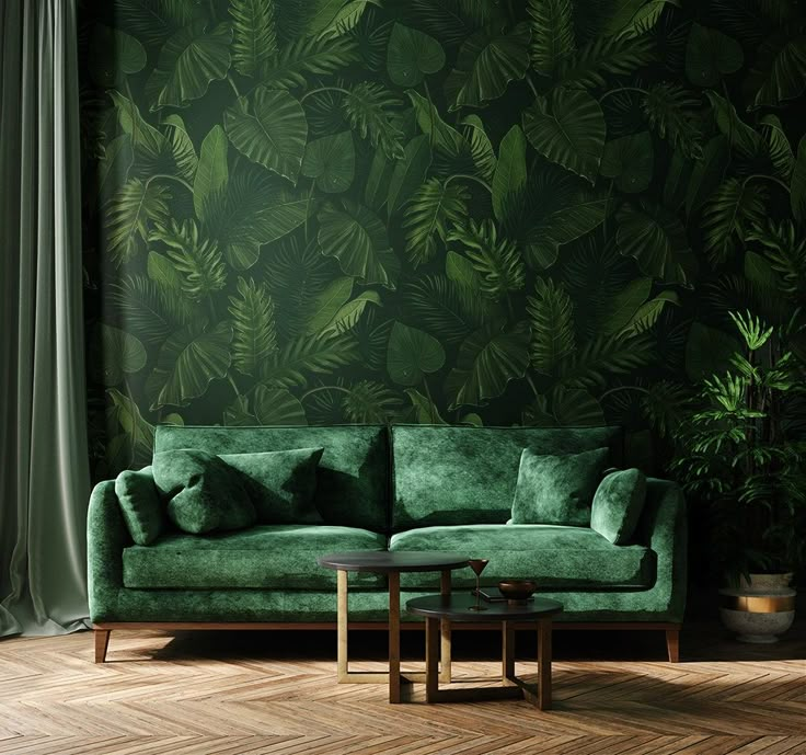 a green couch sitting in front of a window next to a wooden table with a plant on it