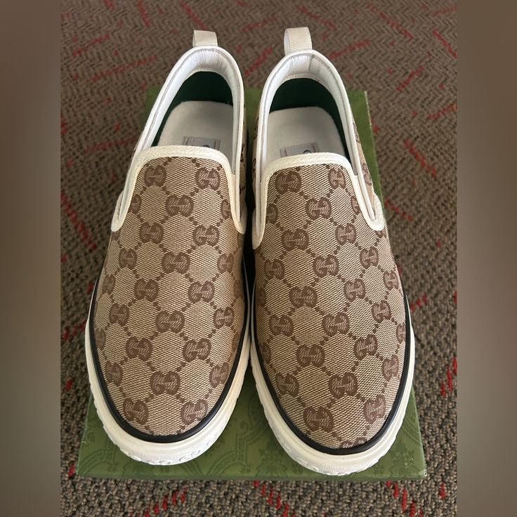 Size: 8 1/2 Gucci Tennis 1977 Beige Canvas Slip-On Sneakers Designer Beige Sneakers With Rubber Sole, Luxury Low-top Slip-on Sneakers With Branded Insole, Luxury Beige Round Toe Sneakers, Gucci Low-top Cream Sneakers, Gucci Beige Low-top Sneakers, Designer Brown Sneakers With Rubber Sole, Designer Slip-on Sneakers With Branded Insole, Gucci Cream Low-top Sneakers, Beige Slip-on Sneakers With Leather Sole