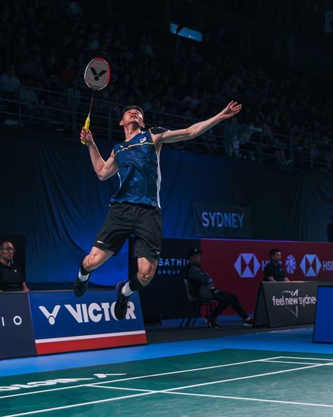 a man jumping in the air to hit a tennis ball with his racquet