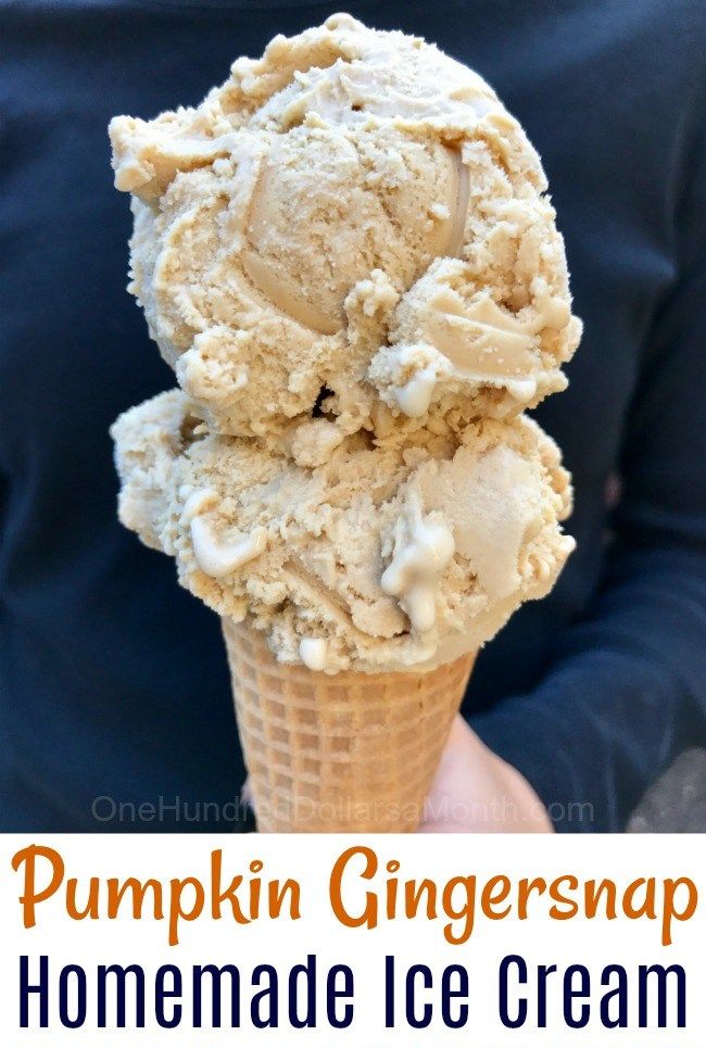 a person holding an ice cream cone filled with pumpkin ginger snaps and caramel chunks