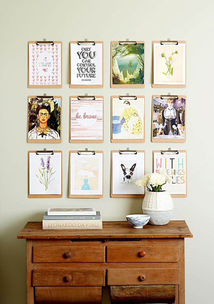 a wooden dresser sitting next to a wall with pictures on it