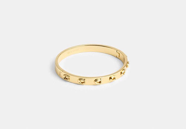 Pegged Signature Hinged Bangle | COACH Coach Metal Bangle Jewelry, Coach Formal Bracelet Jewelry, Luxury Adjustable Coach Jewelry, Coach Formal Bracelet, Adjustable Coach Bangle, Classic Coach Bangle Jewelry, Coach Adjustable Bangle, Coach Gold Bangle Bracelet, Coach Classic Bangle Jewelry