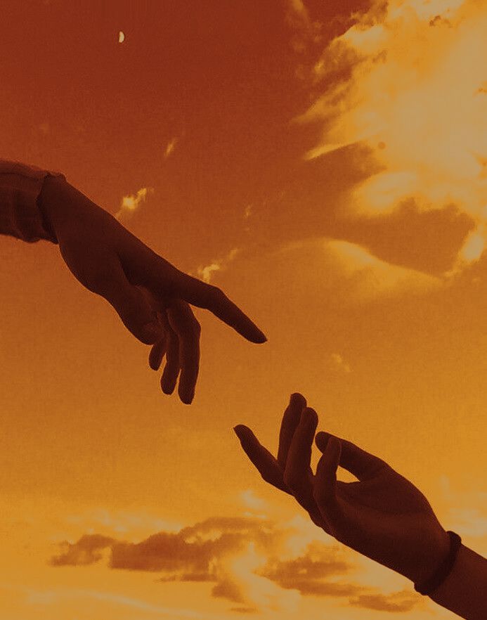 two hands reaching out towards each other in front of an orange sky with white clouds