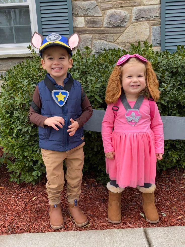 two children dressed in costumes standing next to each other