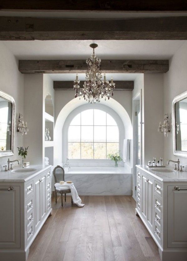 a large bathroom with two sinks and a chandelier