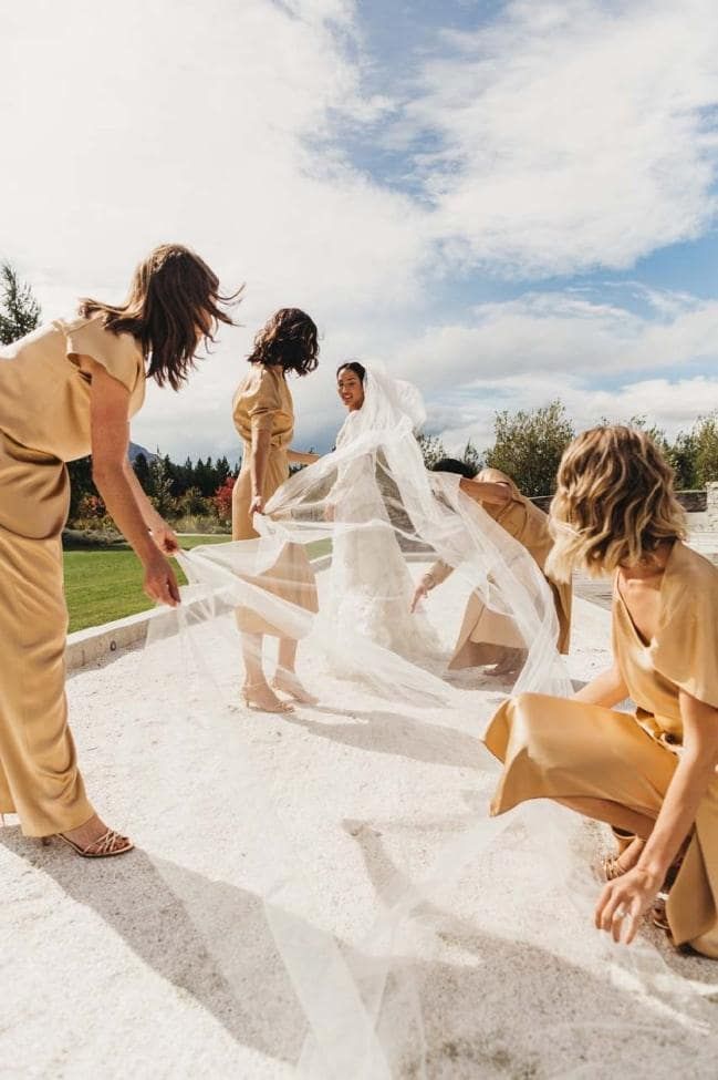 three women in yellow dresses and veils on the ground