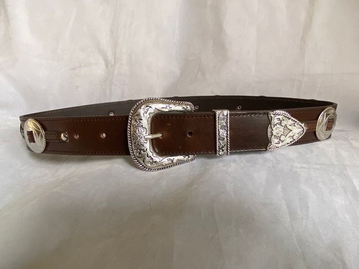 100% Genuine Leather  Australian Made  This is a 38mm (1 1/2") brown leather belt with a three piece Weston buckle set and big concord down the belt ( can be big and small conchos please ask) stitched in a brown  thread ( can be stitched in a silver thread, please ask) once you buy the belt just add a note to seller with the waist size you would like,  Waist size is from the buckle end of the leather to the middle hole then you will have three holes bigger and three holes smaller Classic Brown Belt For Ranch, Brown Leather Rodeo Belt, Brown Belt Buckle With Buckle Closure For Formal Occasions, Brown Leather Belt For Rodeo, Brown Formal Belt Buckle With Buckle Closure, Formal Brown Belt Buckle With Buckle Closure, Formal Brown Belt Buckle With Closure, Classic Brown Belt Buckles For Western-themed Events, Adjustable Brown Belt Buckles For Rodeo