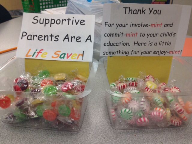 two plastic containers filled with candies on top of a table next to each other