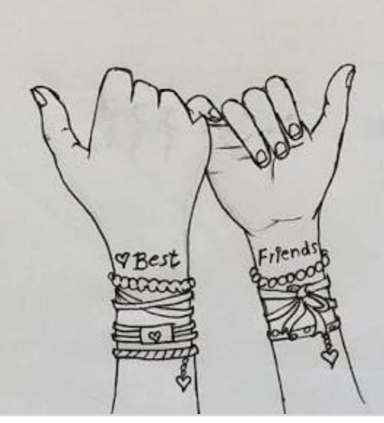 two hands with wristbands that say best friends