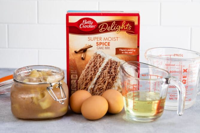 ingredients for cake sitting on top of a counter next to a measuring cup and bowl