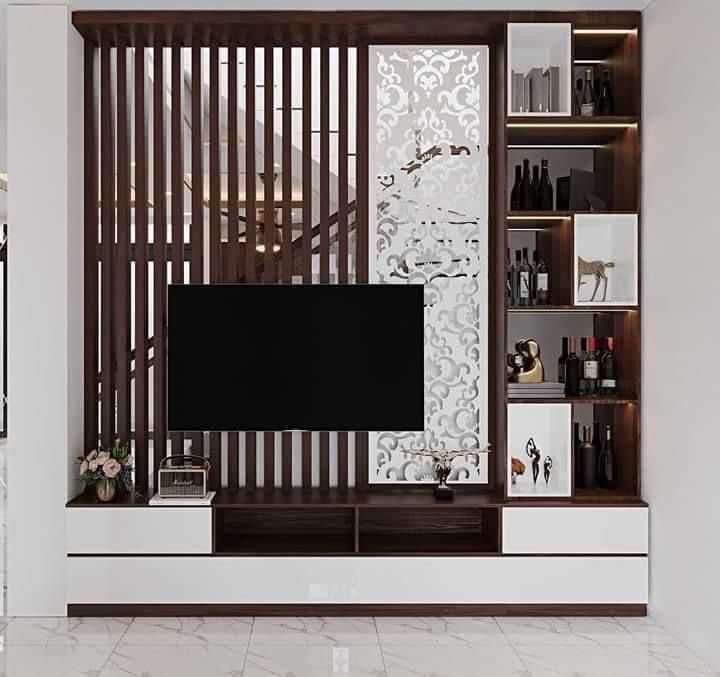 a living room with white walls and wooden slats on the wall, along with an entertainment center