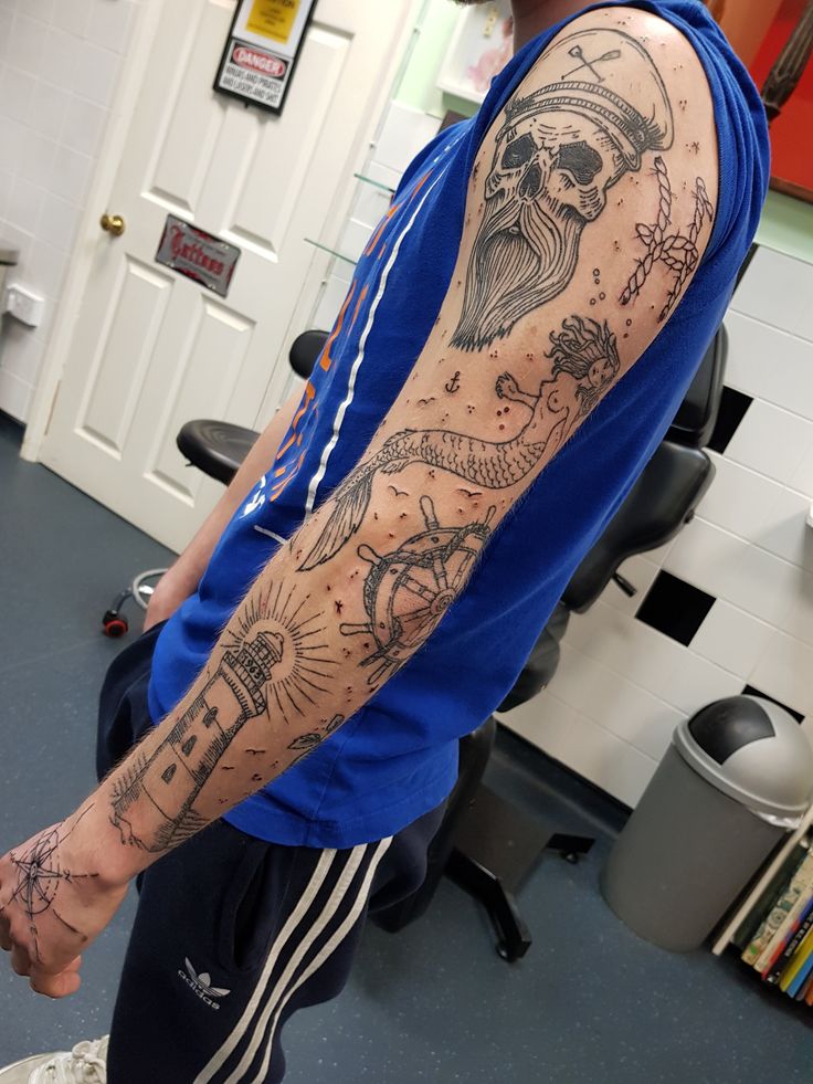 a man with a tattoo on his arm