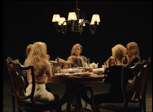 several women sitting around a table eating food